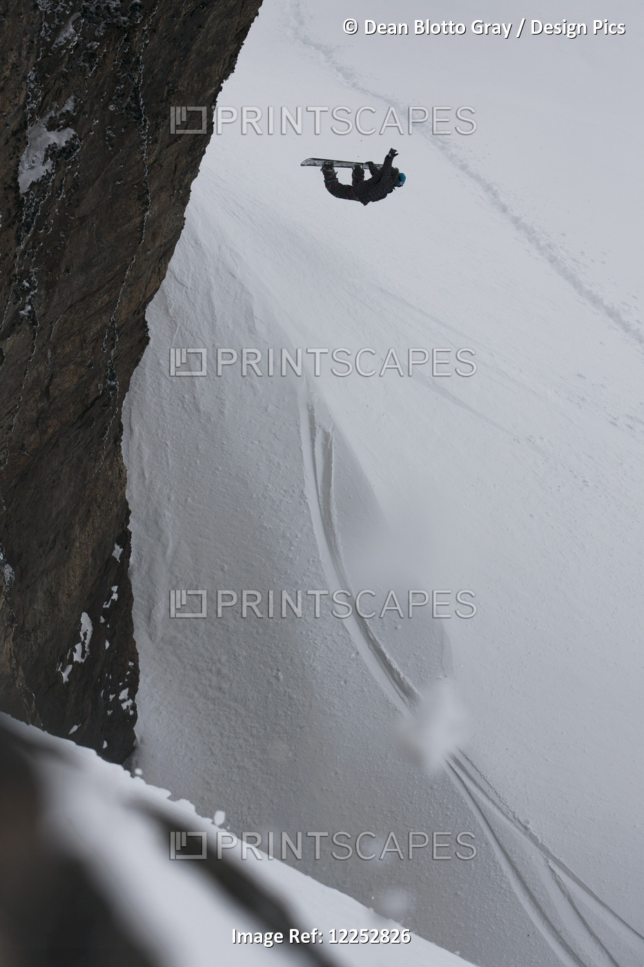 Professional Snowboarder Making An Extreme Jump Of A Vertical Wall Near ...