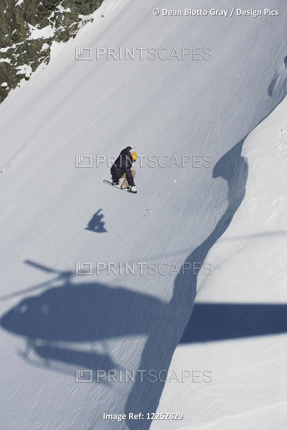 Professional Snowboarder, David Porcheron, Makes A Jump Down A Steep Slope With ...