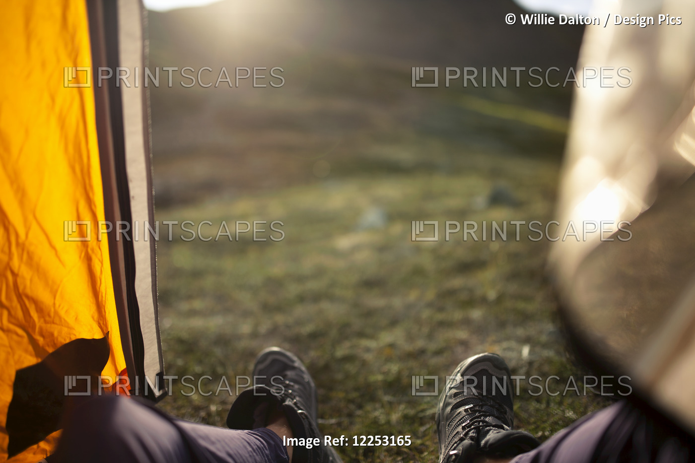 Pov View Of Hikers Feet And The View Of Tundra From The Doorway Of A Tent, ...