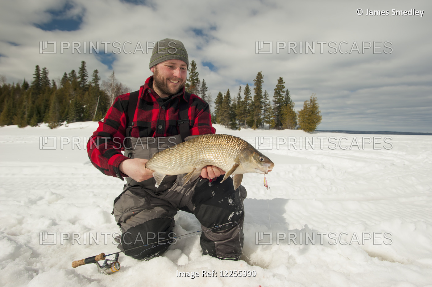 Ice Fisherman Holding A Large Whitefish; Ontario, Canada