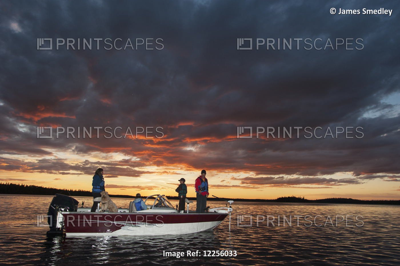 A Family Fishing From Their Motorboat On A Calm Lake At Sunset In Northern ...