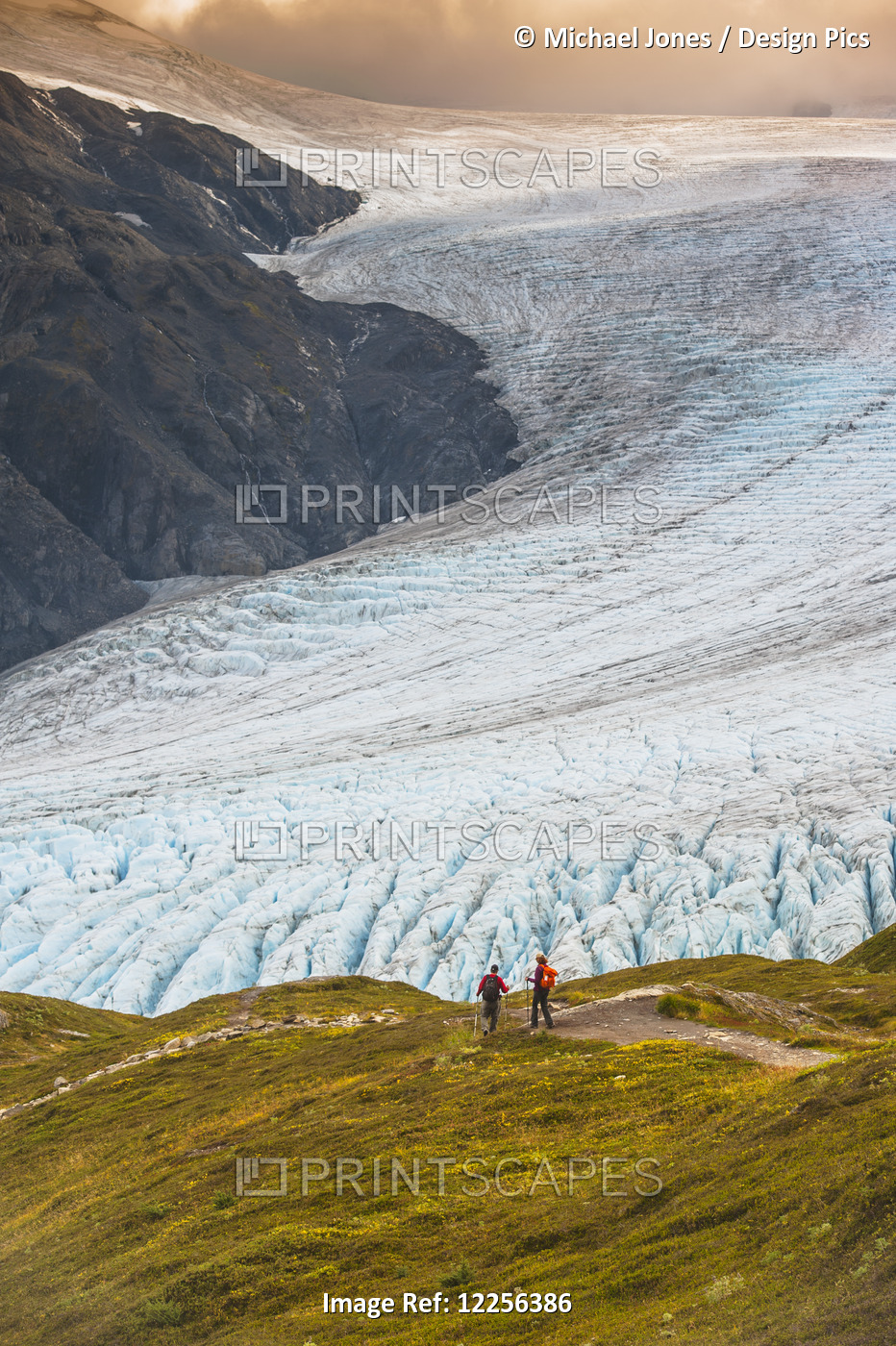 A Man And Woman Hiking Down The Harding Icefield Trail With Exit Glacier In The ...