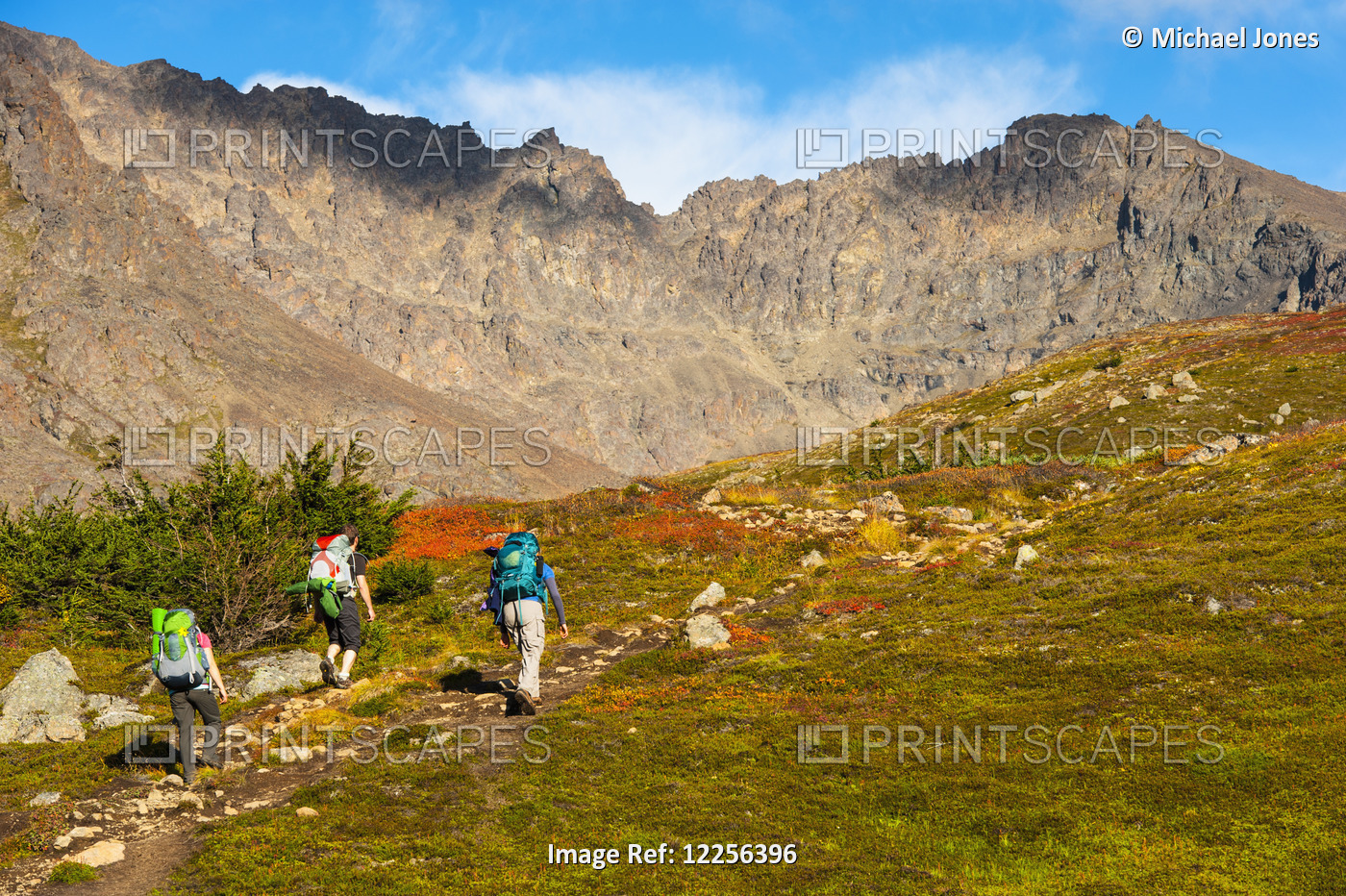 Three Backpackers Are Hiking Up The Hidden Lake Trail In The Chugach State Park ...
