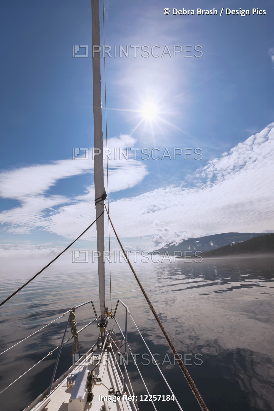 A Sailboat Journeys On Johnstone Strait Along The Coast; British Columbia, ...