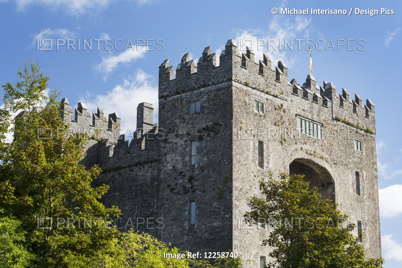 Stone Castle With Trees, Blue Sky And Clouds; Bunratty, County Clare, Ireland