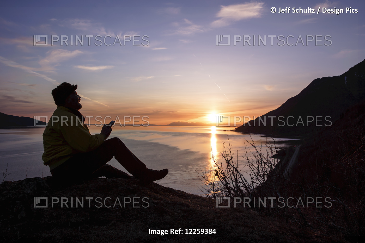 Silhouette Of A Man Using A Smart Phone At Sunset Overlooking Turnagain Arm, ...