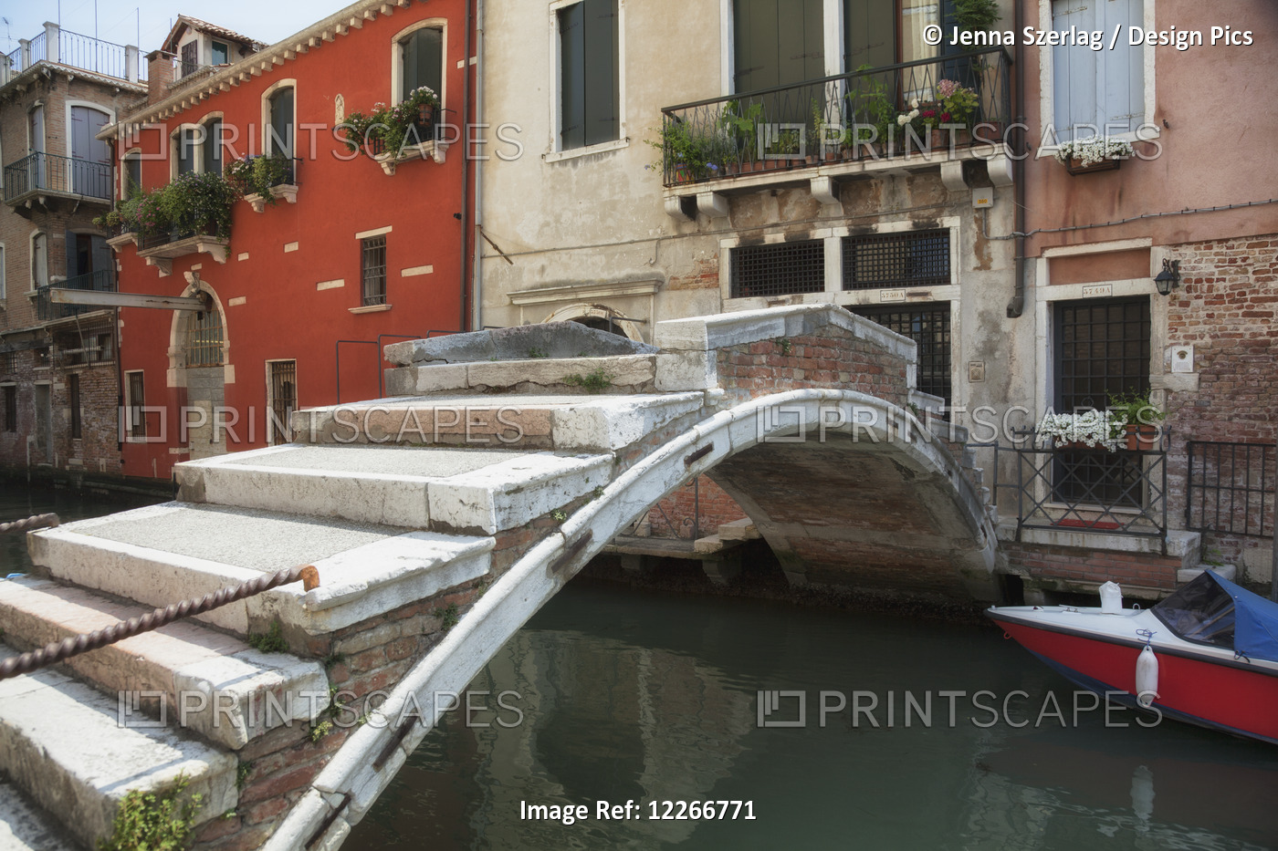 A Quaint Bridge Crosses A Small Canal; Venice, Italy