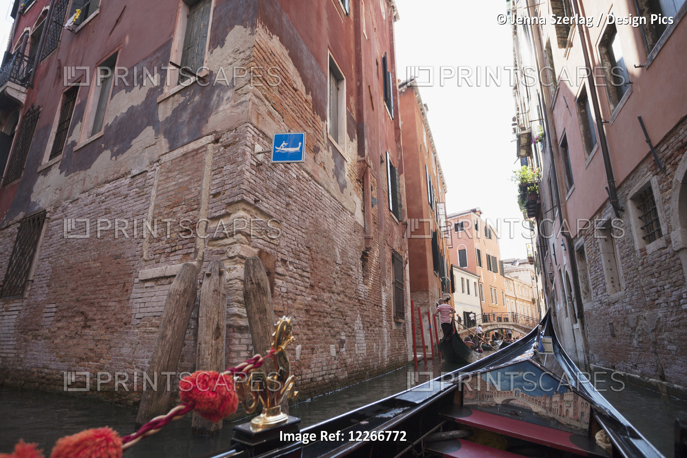 View Of Buildings Along A Narrow Canal From A Gondola; Venice, Italy