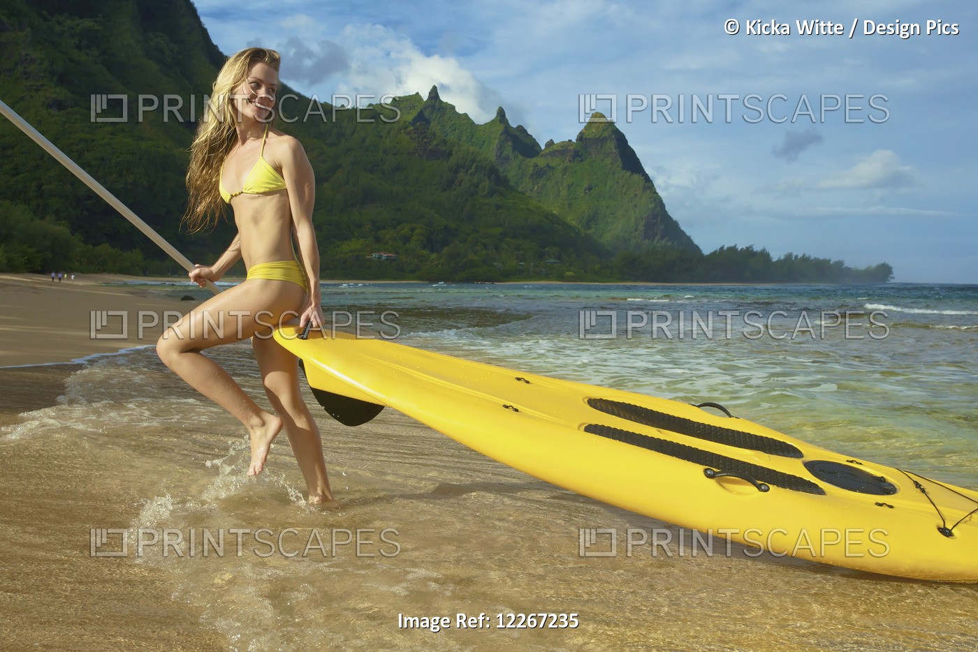 Young Woman With Stand Up Paddle Board; Kauai, Hawaii, United States Of America