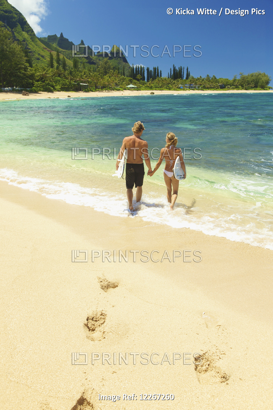Couple Walking Into Water With Bodyboards; Kauai, Hawaii, United States Of ...