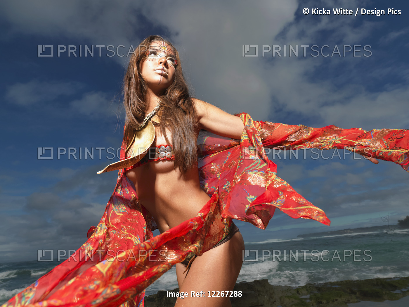 Young Woman Posing On A Beach In A Bikini And Tribal Face Paint; Kauai, Hawaii, ...