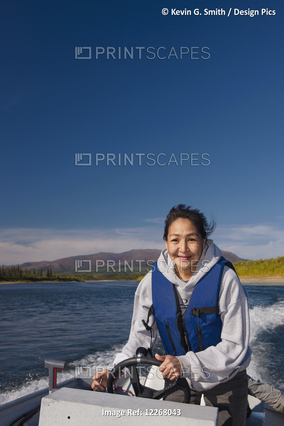 Alaskan Native Female Driving A Motor Boat On Kobuk River, Arctic Alaska, Summer