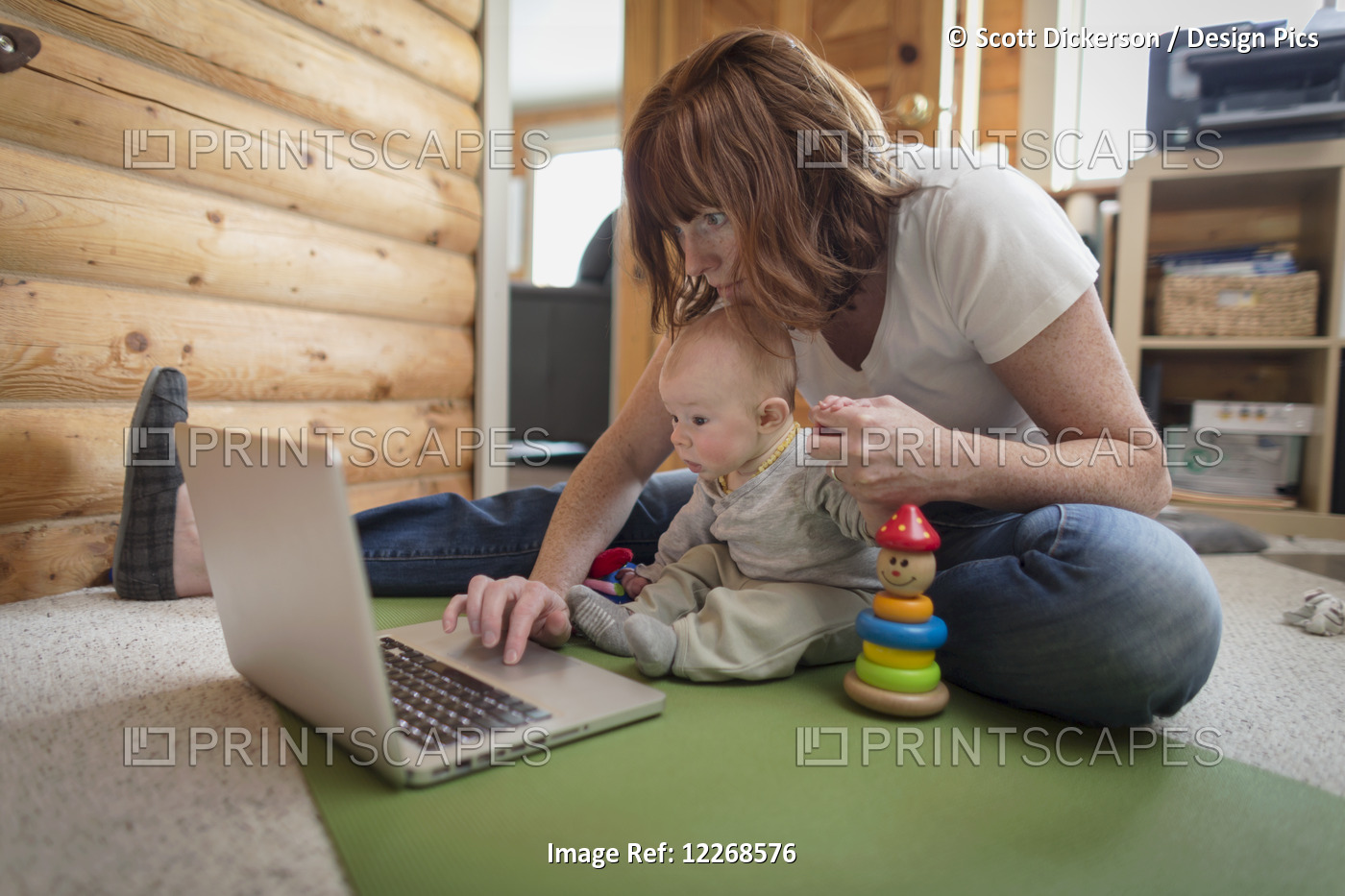 Mother And Baby Sitting In Front Of A Laptop On The Floor Of A Cabin, Homer, ...