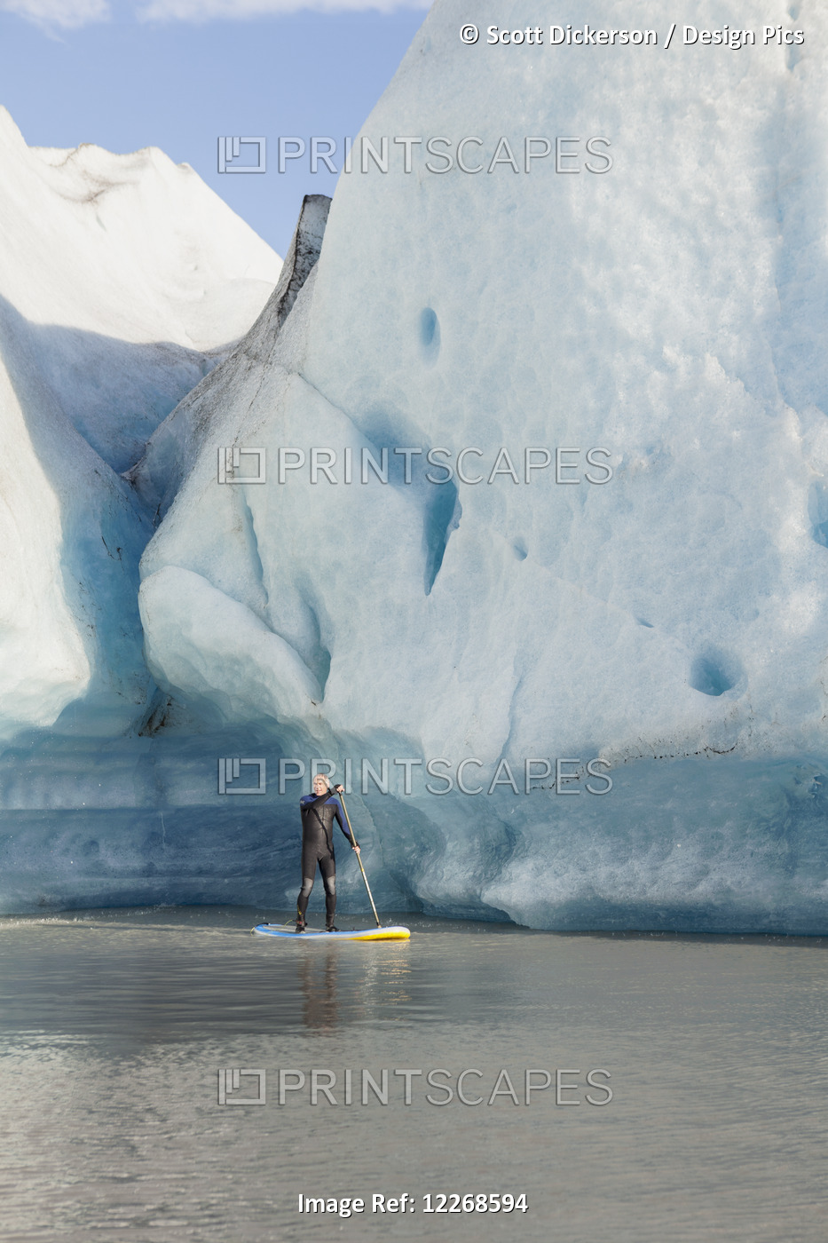 One Person Stand Up Paddleboarding In Front Of Grewingk Glacier, Kachemak Bay ...