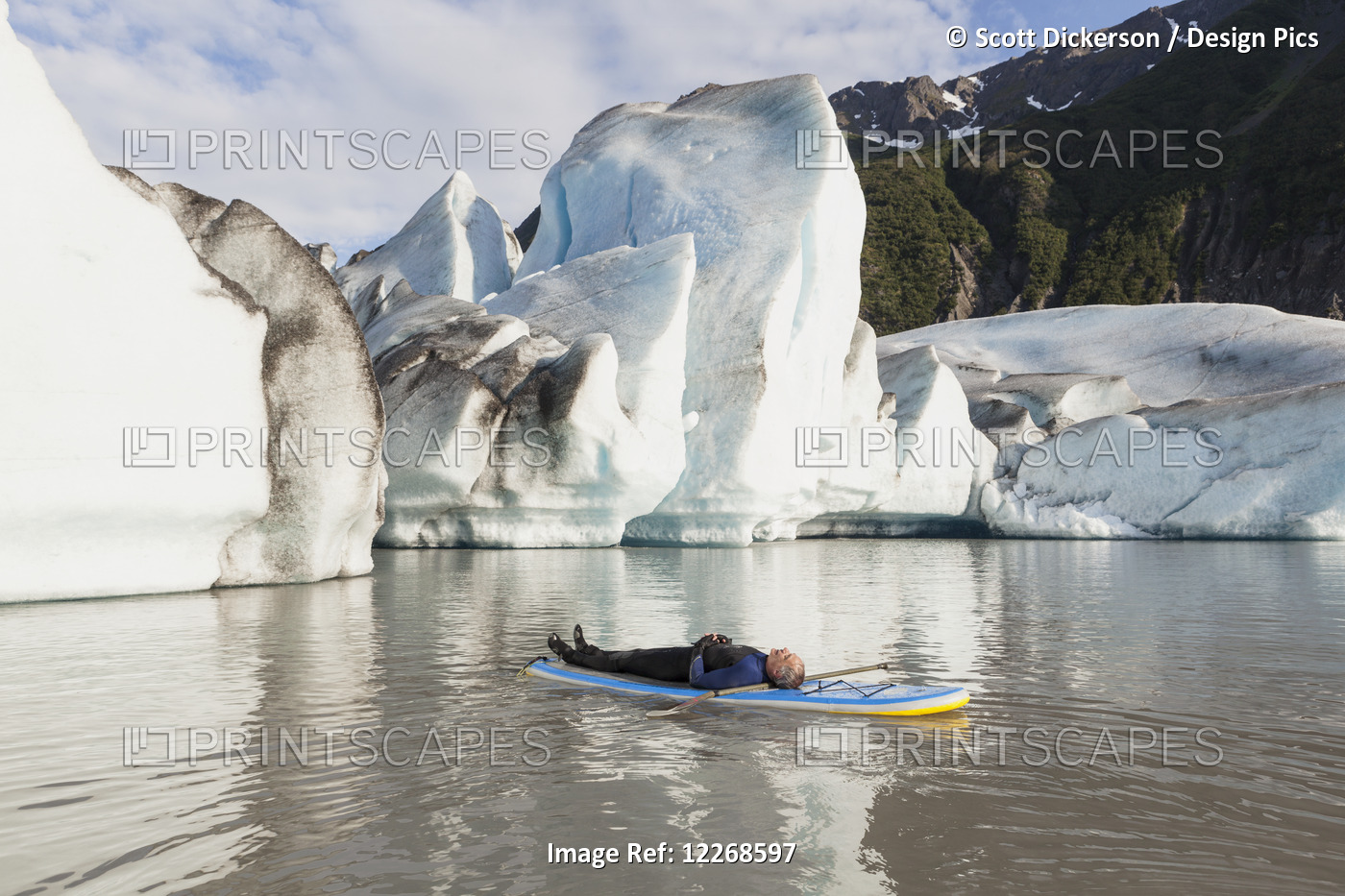 Man Laying On A Standup Paddleboard In Front Of Grewingk Glacier In Kachemak ...