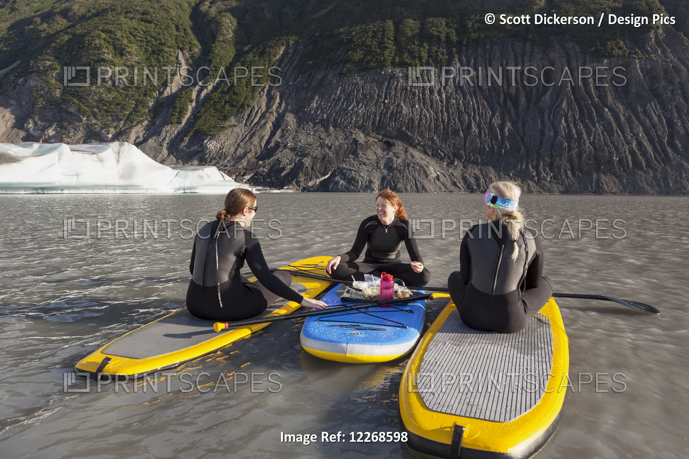 Three Women Sitting On Top Of Their Inflatable Stand Up Paddle Boards Eating A ...