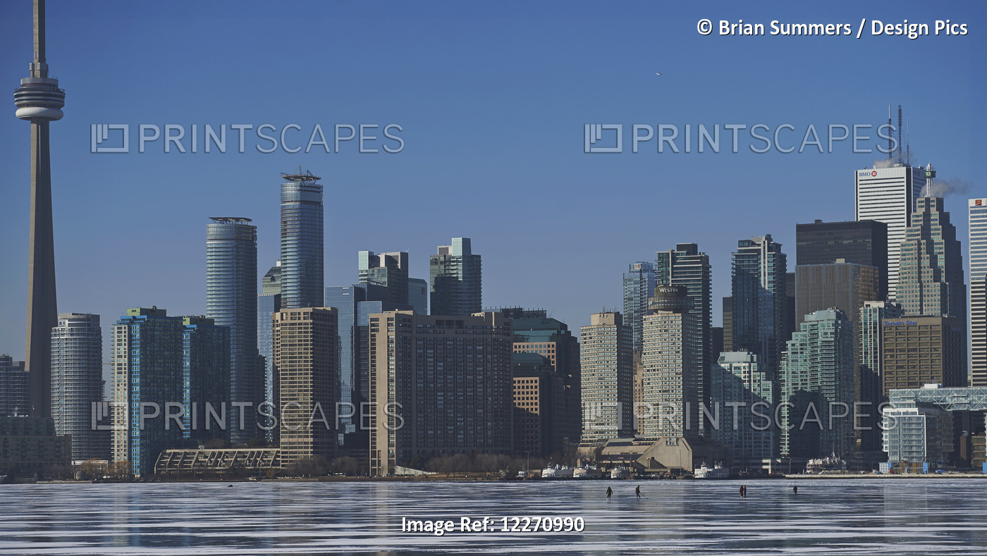 People In The Distance On The Ice Against City Skyline From Ward's Island; ...
