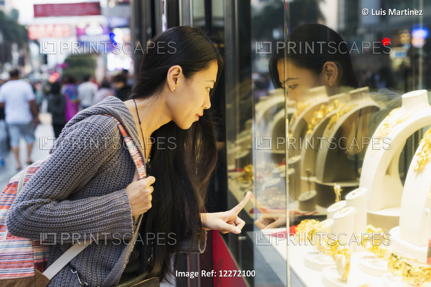 A Young Woman Window Shopping At The Retail Shops Along The Street, Kowloon; ...
