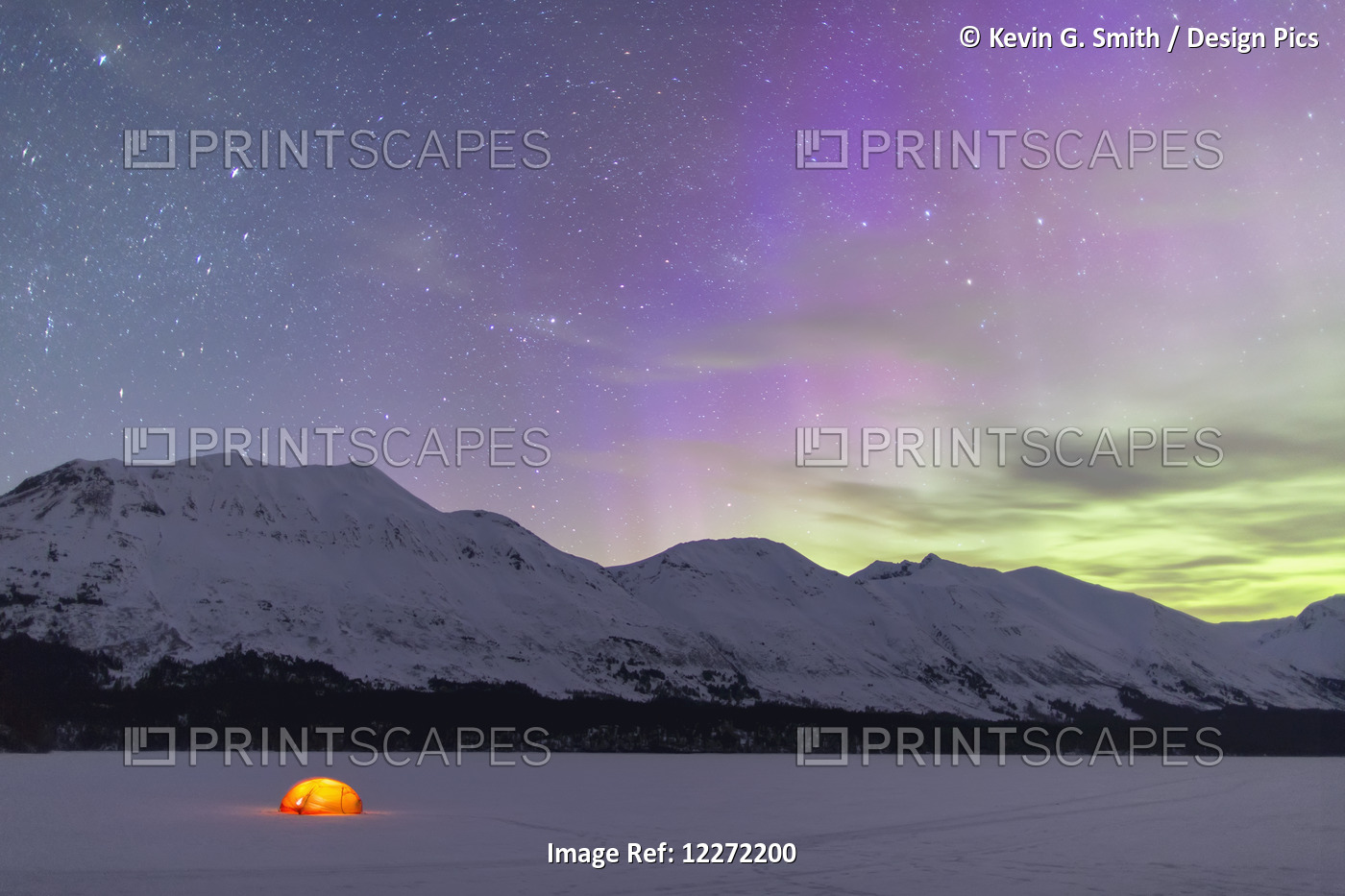 Nighttime View Of A Lit Tent On A Snow Covered Trail Lake With The Moon, Stars, ...