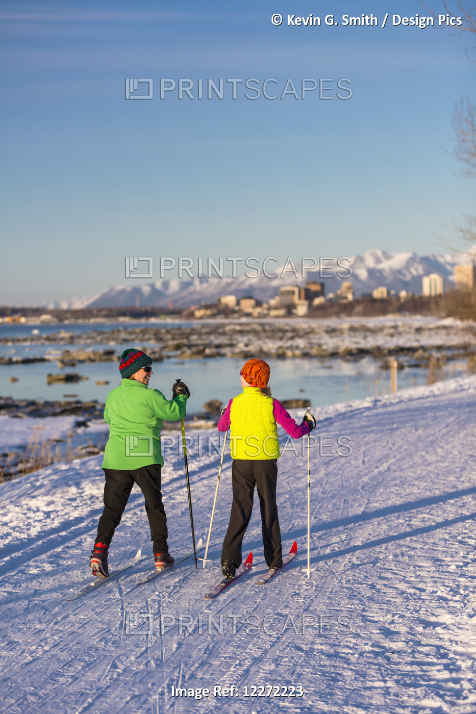 Two People Cross Country Skiing On The Tony Knowles Coastal Trail With ...