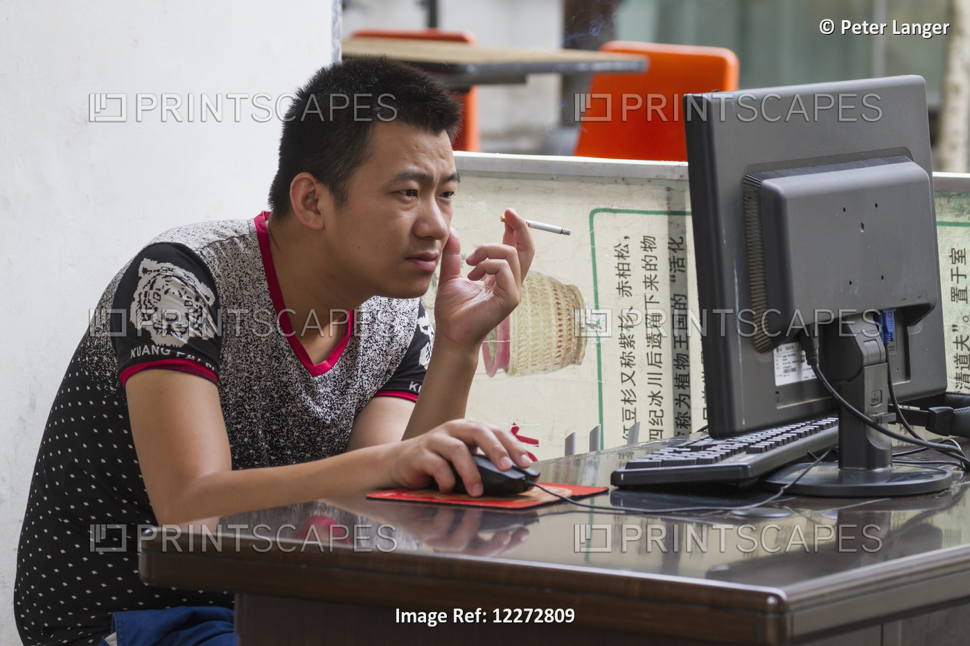 Man Smoking On A Computer, Hongcun, Anhui, China