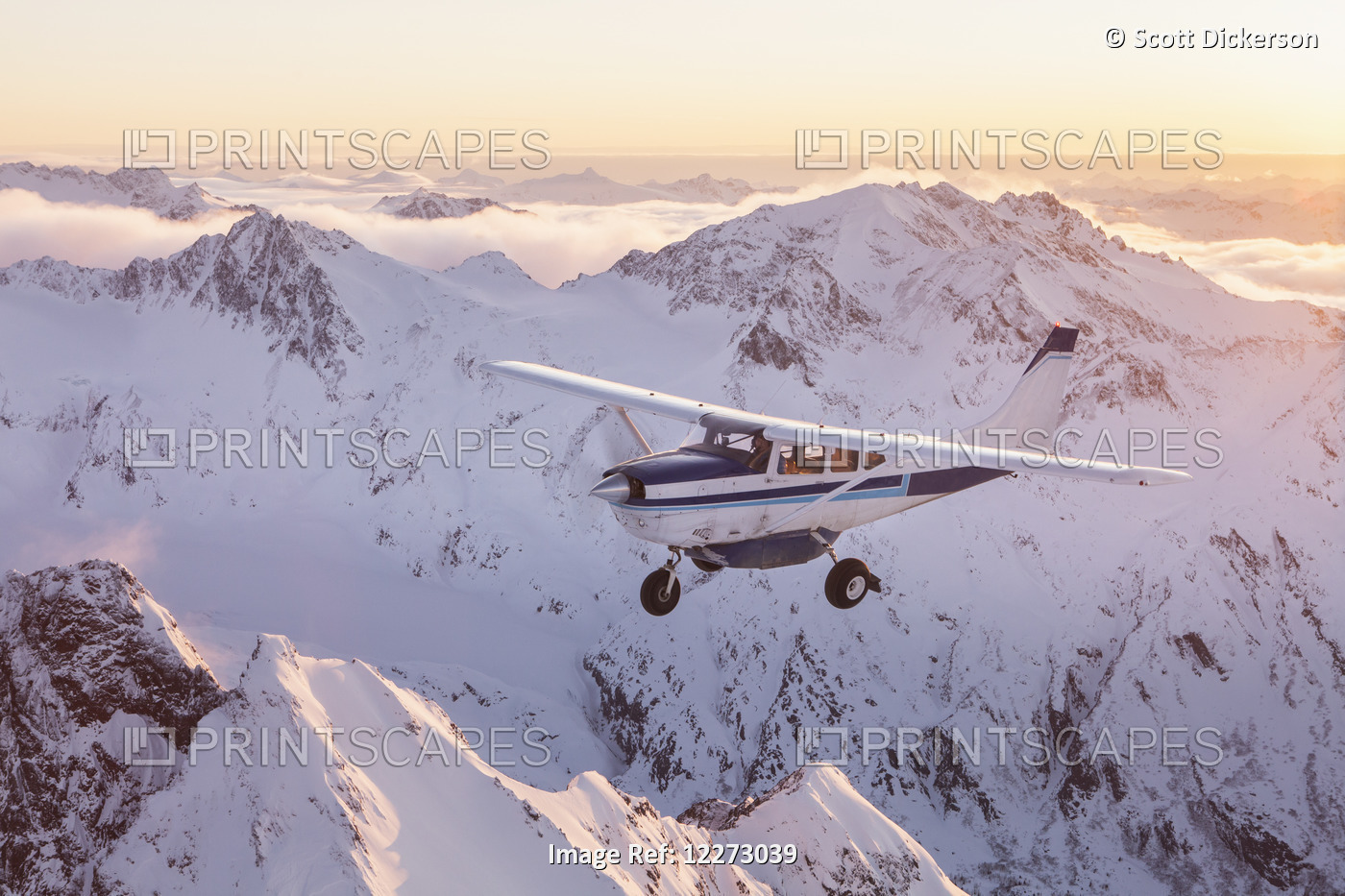 A Cessna 206 Flies Over Fog Enshrouded Mountain Ridges During A Flightseeing ...