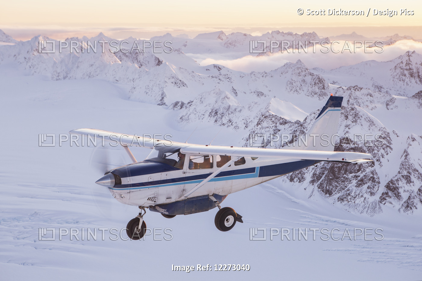 A Cessna 206 Flies Over The Glaciers, Ice Fields And Rugged Peaks Of The Kenai ...