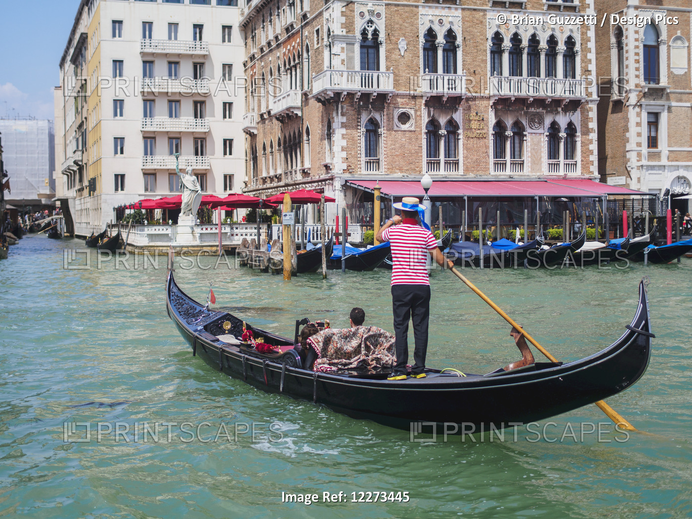 A Gondolier Maneuvers His Gondola On The Grand Canal; Venice, Italy