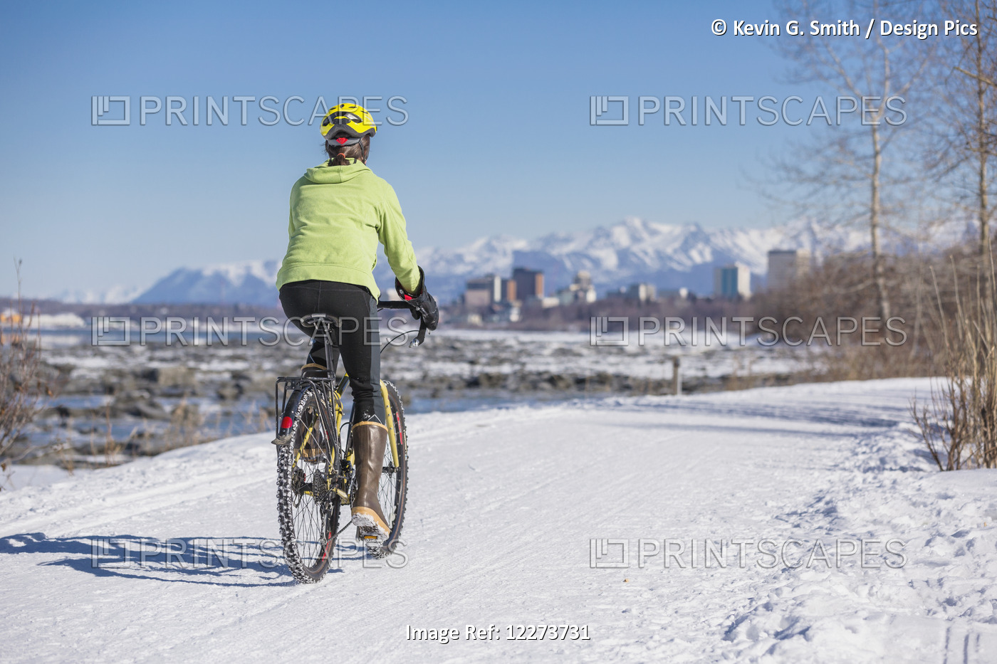 A Young Woman Rides A Studded Tire Bicycle Down The Tony Knowles Coastal Trail, ...