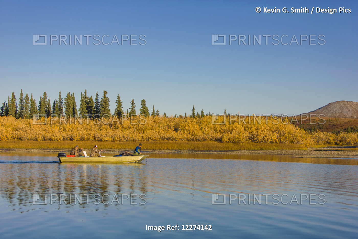 Three People In A Skiff Drive Down The Noatak River With Colorful Willows Along ...