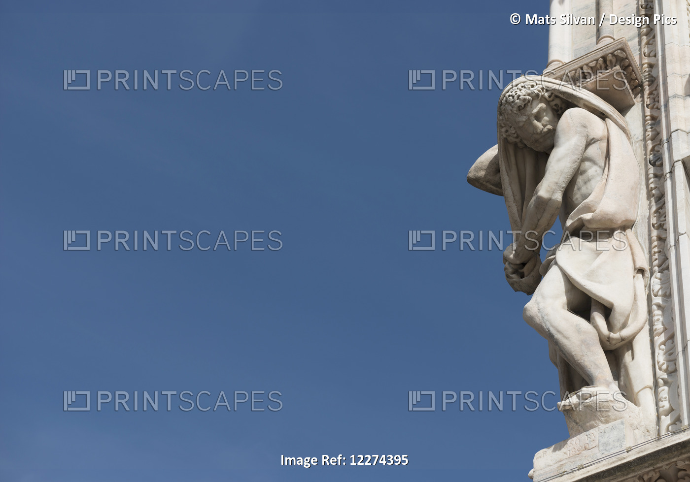 Carved Sculpture Of Male Likeness On The Facade Of Milan Cathedral Against A ...