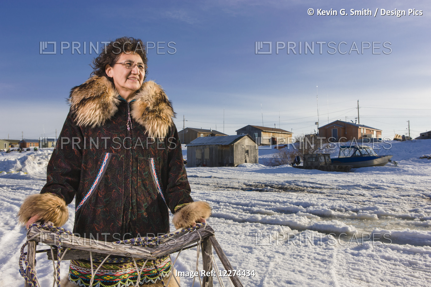 Elder Alaska Native Woman Wearing A Kuspuk Parka Stands Next To A Wooden ...