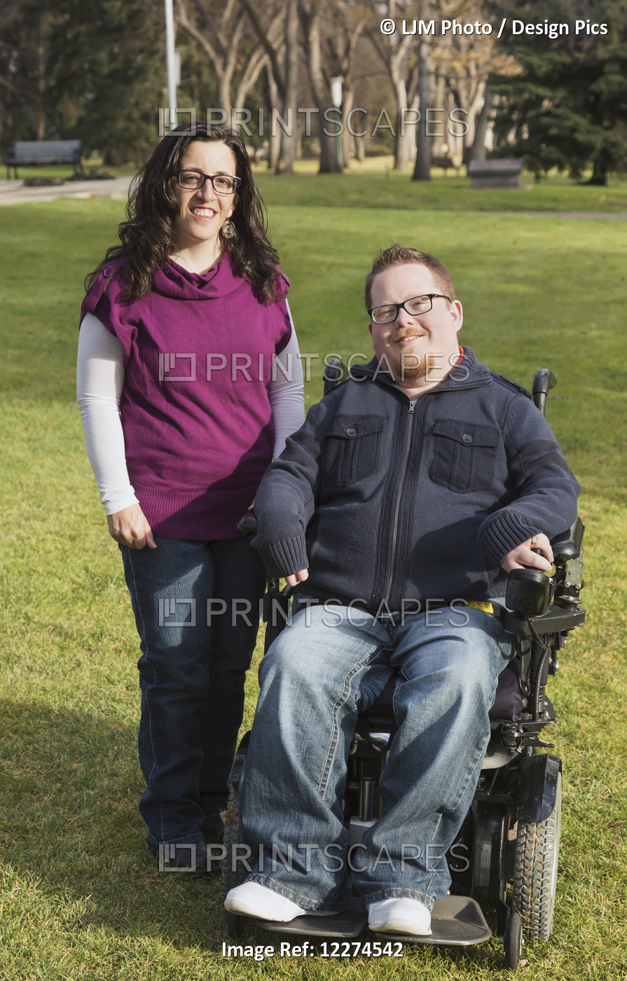 Disabled Husband With His Wife Posing For A Picture In A Park In Autumn; ...