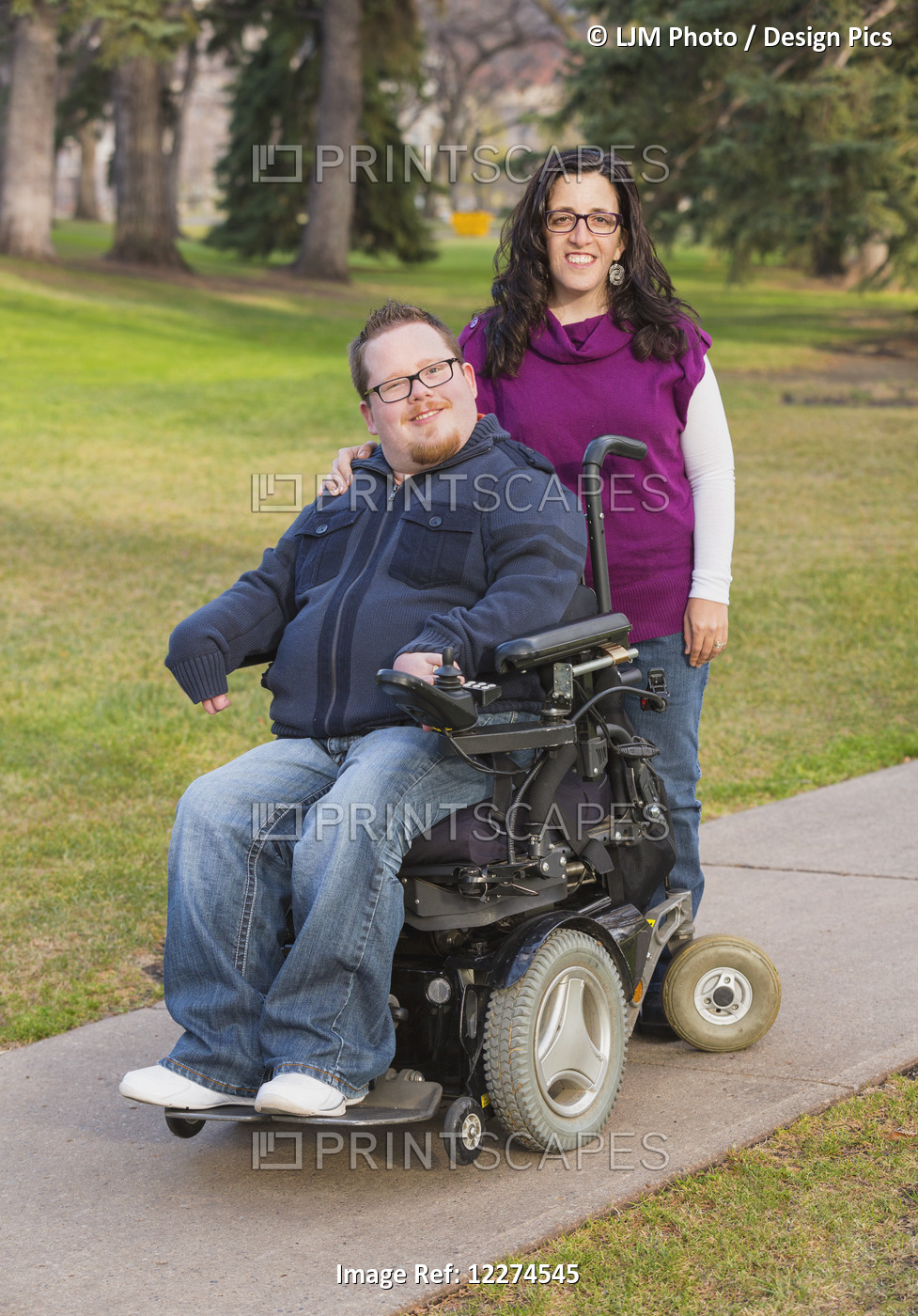 Disabled Husband With His Wife Posing For A Picture In A Park In Autumn; ...