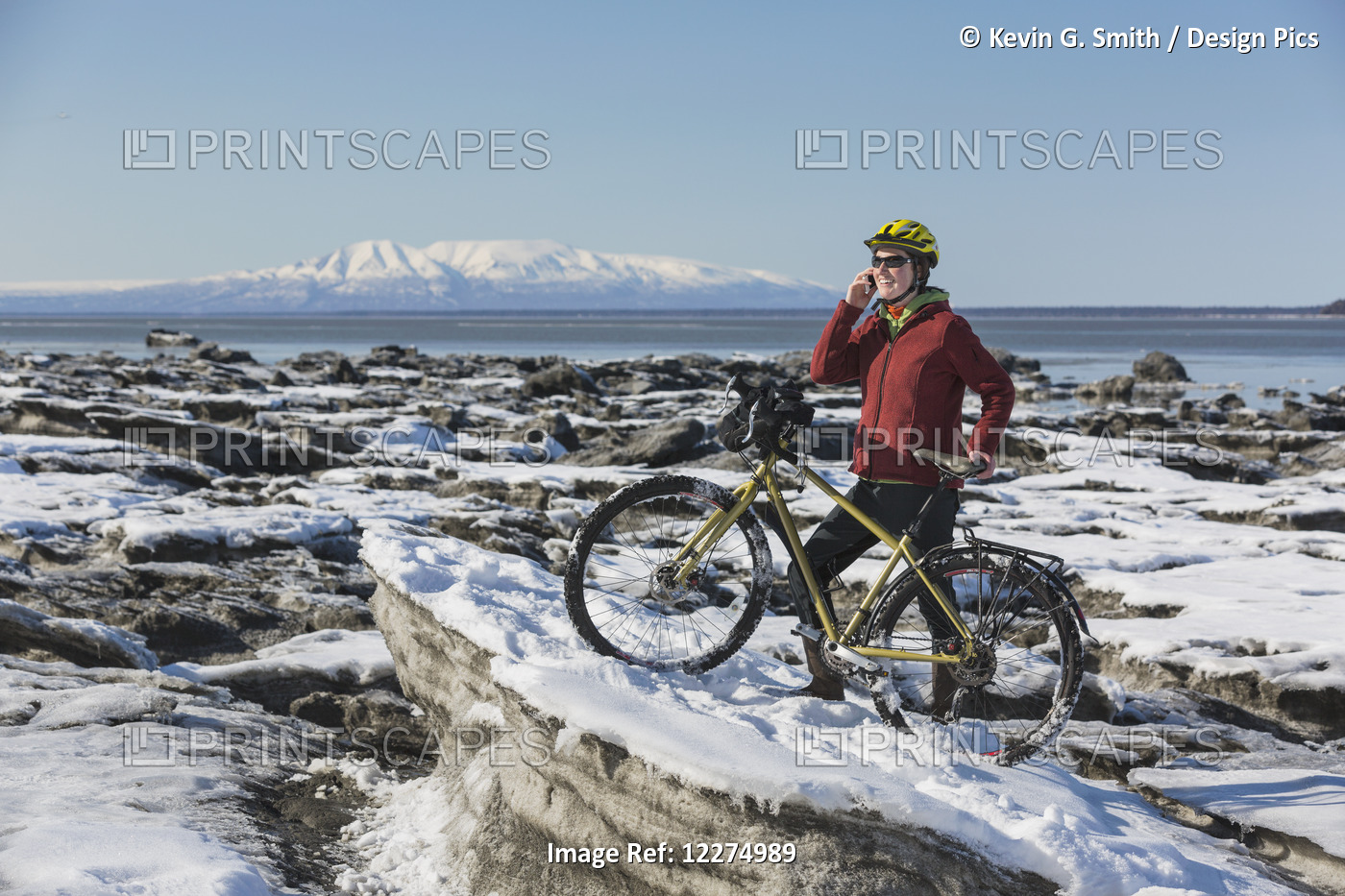 Young Woman With Her Bicycle Talks On A Cell Phone While Standing On Frozen Ice ...