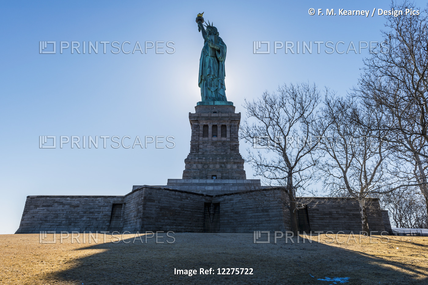 Sun Setting Behind The Statue Of Liberty, Liberty Island; New York City, New ...