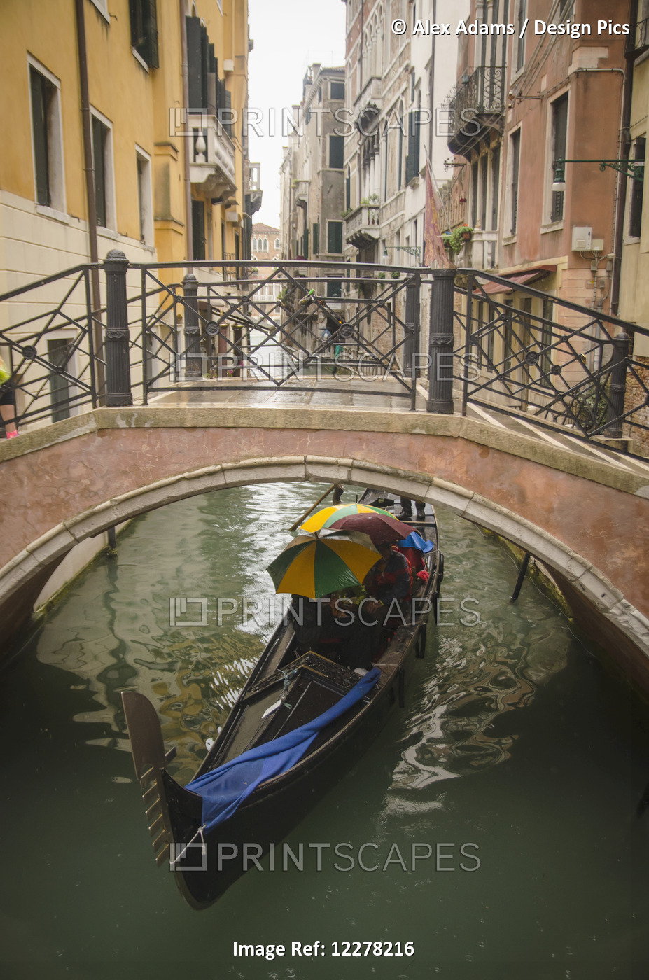 Tourists Punt Down The Canals Of Venice In The Rain; Venice, Italy