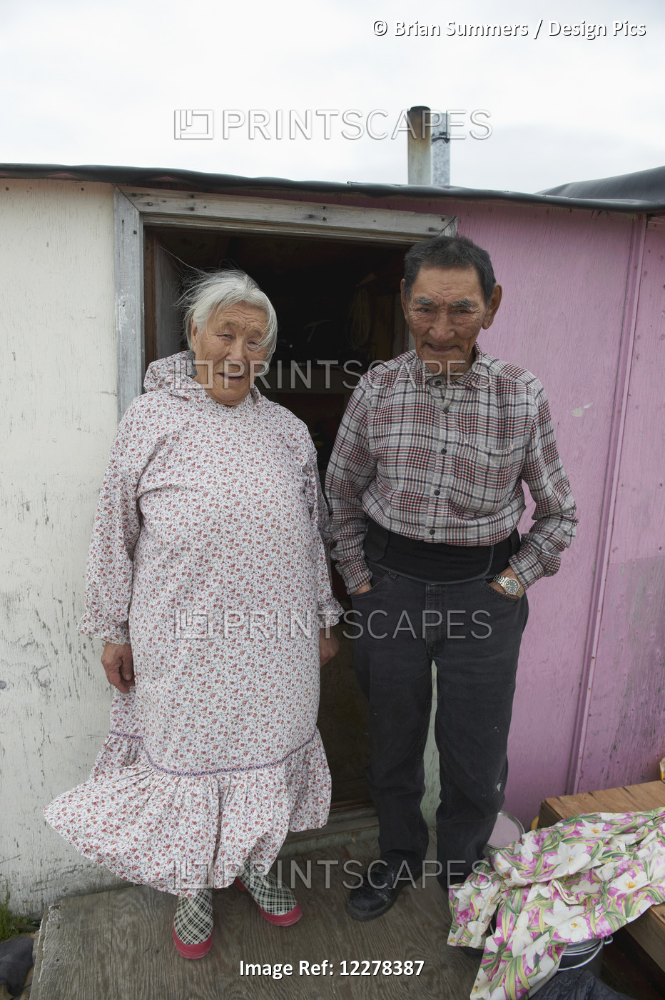 Inuit Elder Couple In The Doorway Of Their Cabin; Cambridge Bay, Victoria ...
