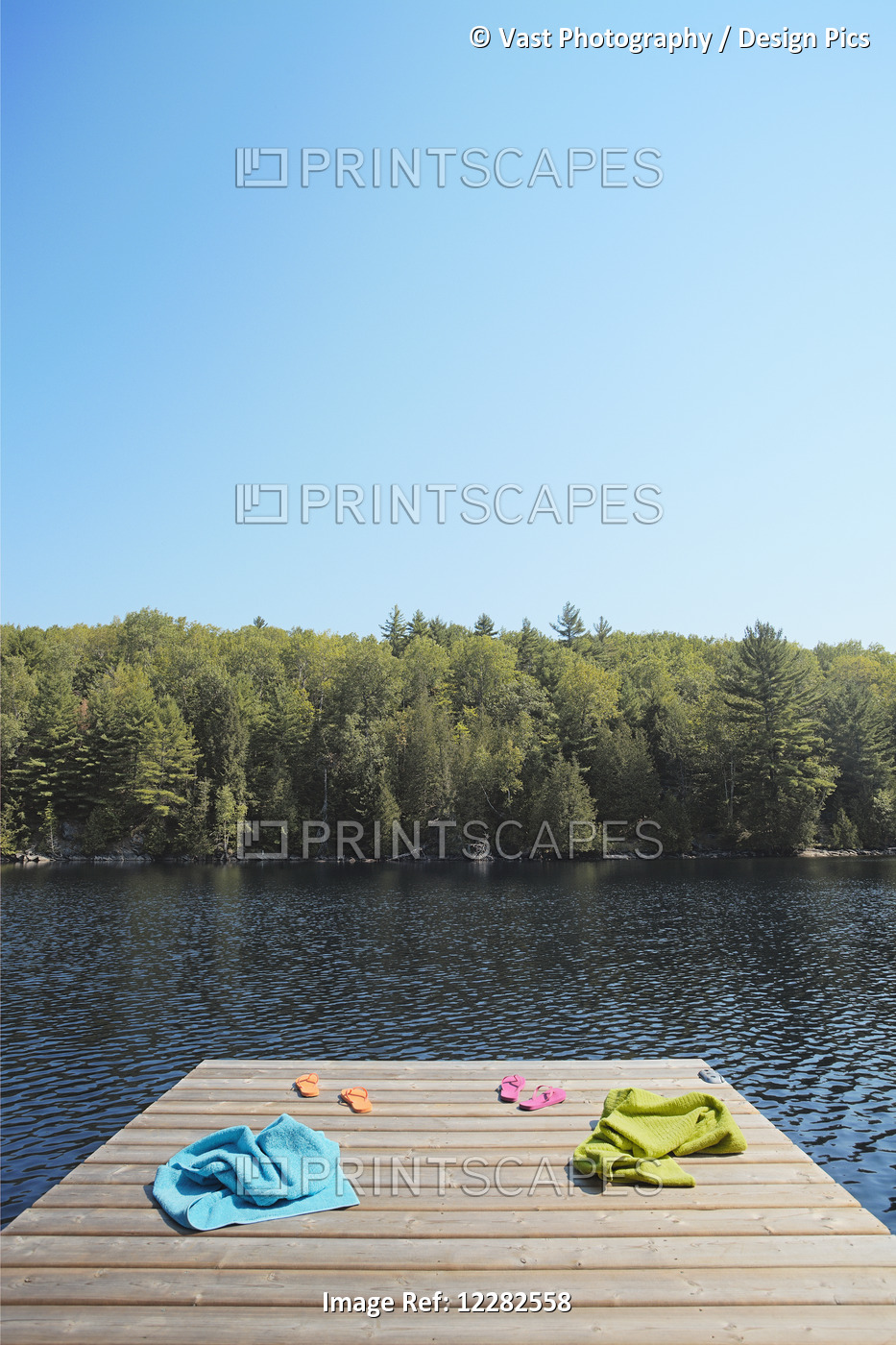 Towels And Flip-Flops On Dock; Crystal Lake, Ontario, Canada