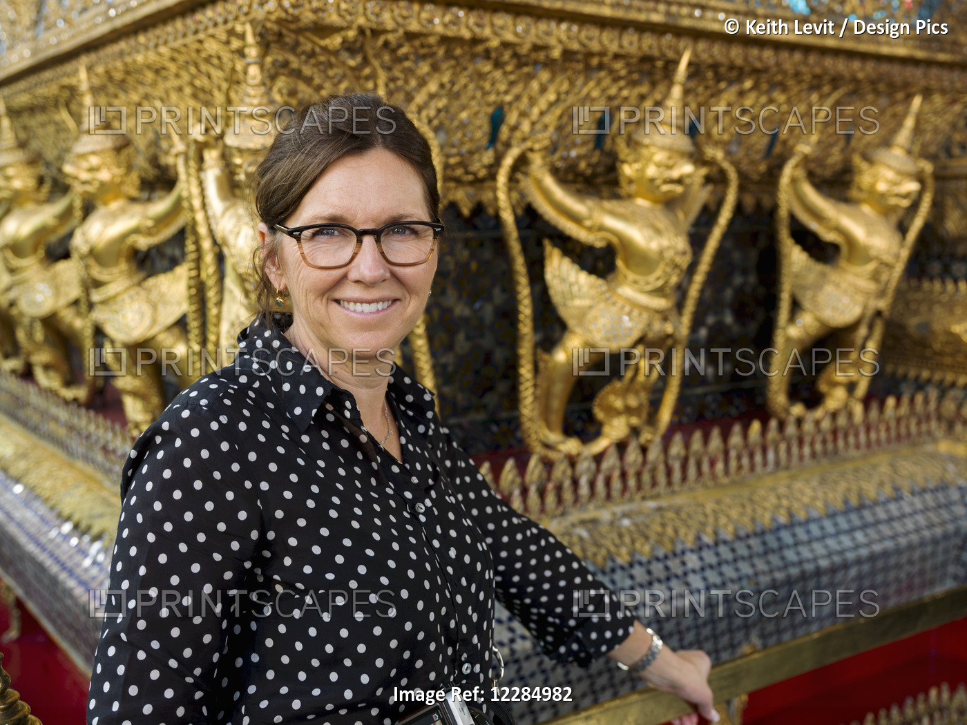 Portrait Of A Woman Standing Beside A Wall With Gold Statues, Temple Of The ...