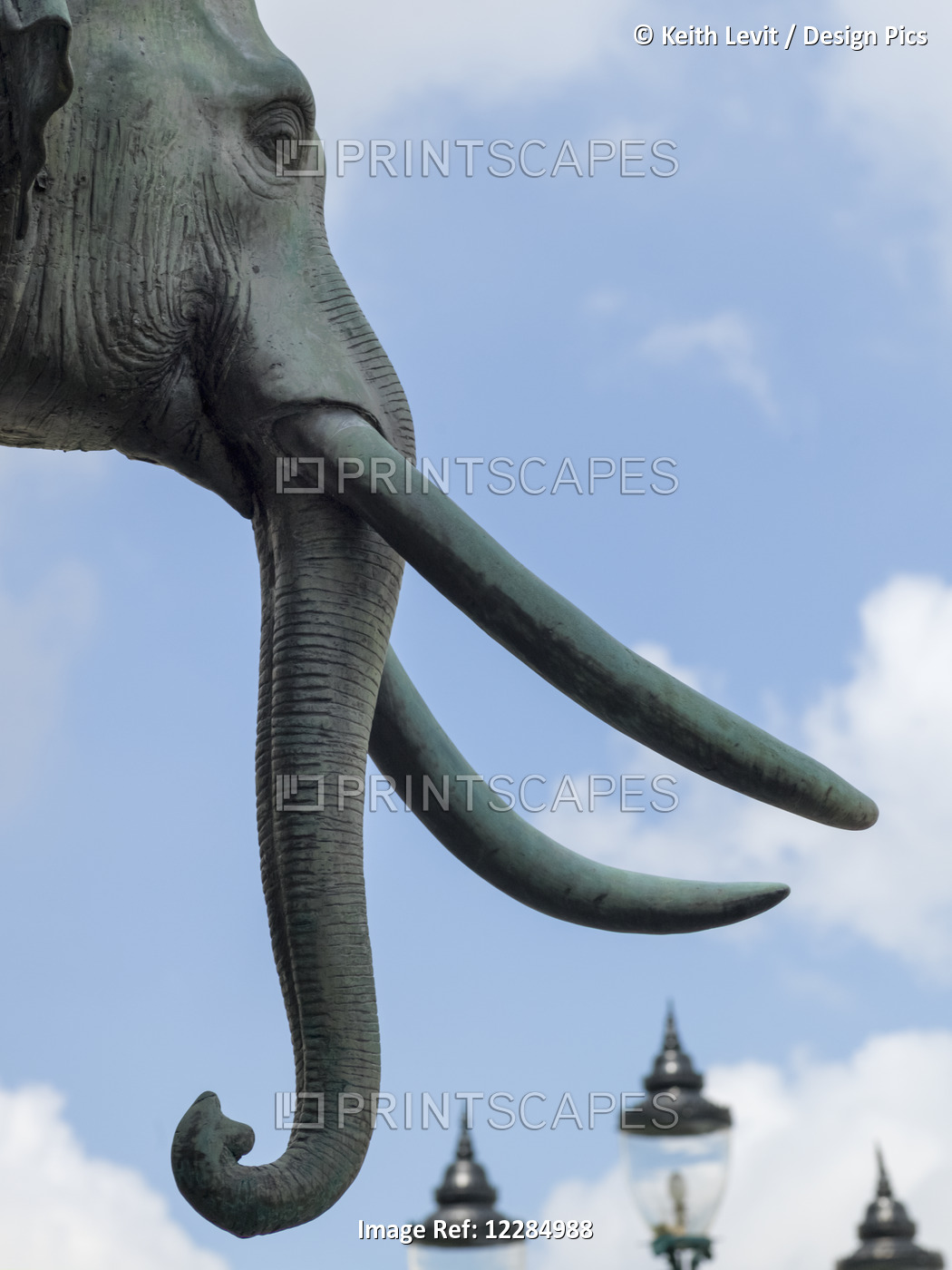 Sculpture Of An Elephant With Tusks And Lamp Posts In The Background; Bangkok, ...