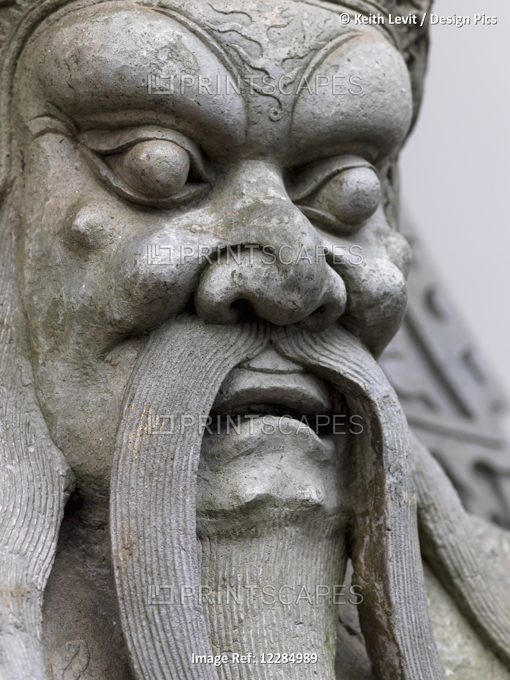 Close Up Of A Carved Stone Statue In Male Likeness; Bangkok, Thailand