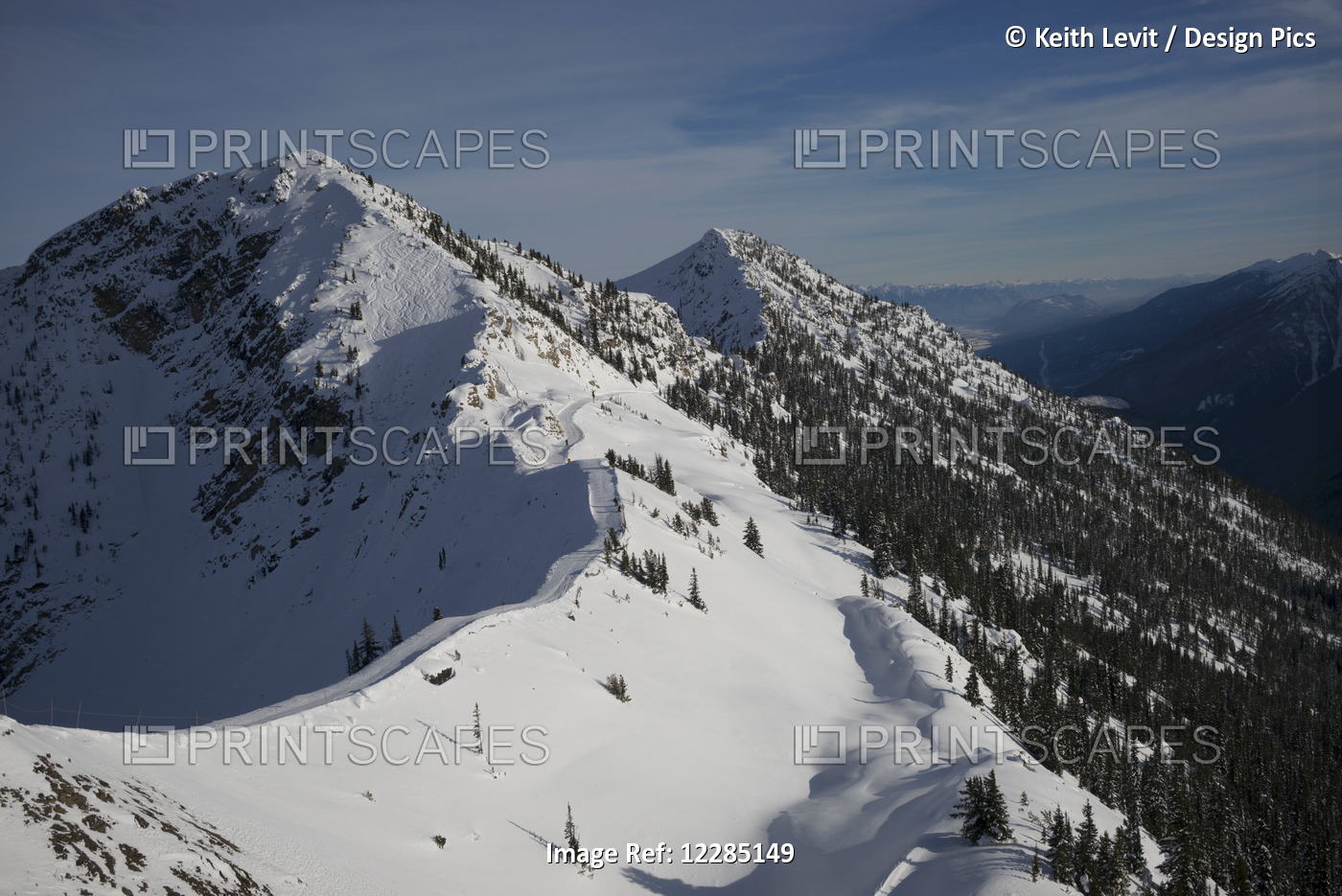 Snowy Mountain Slope With Blue Sky And View Of Mountain Range; Kicking Horse, ...