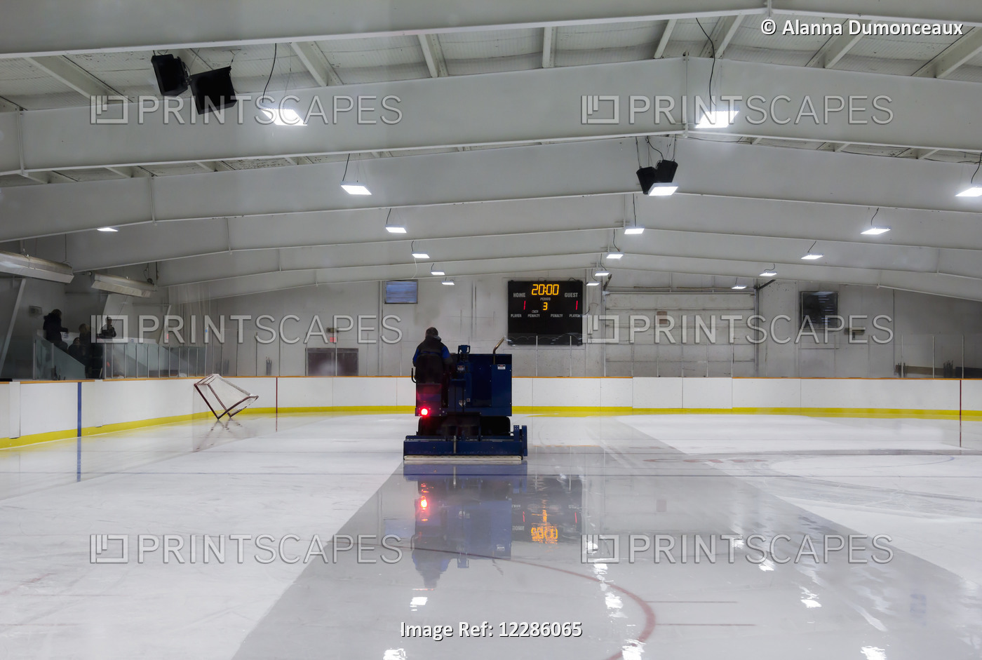 The Zamboni Driver Melts The Ice At An Ice Rink; Alberta, Canada