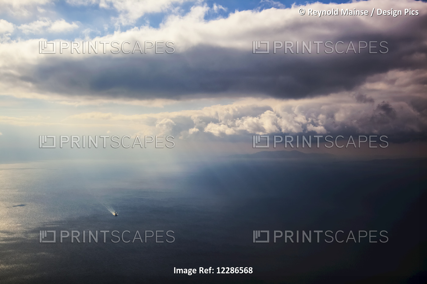 A Lone Boat On The Aegean Sea Under A Cloudy Sky And Distant View Of The ...