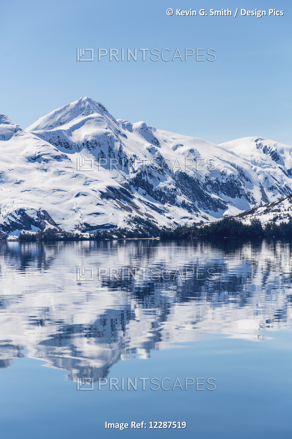 Snow Covered Mountains Reflect In The Calm Waters Of Prince William Sound In ...