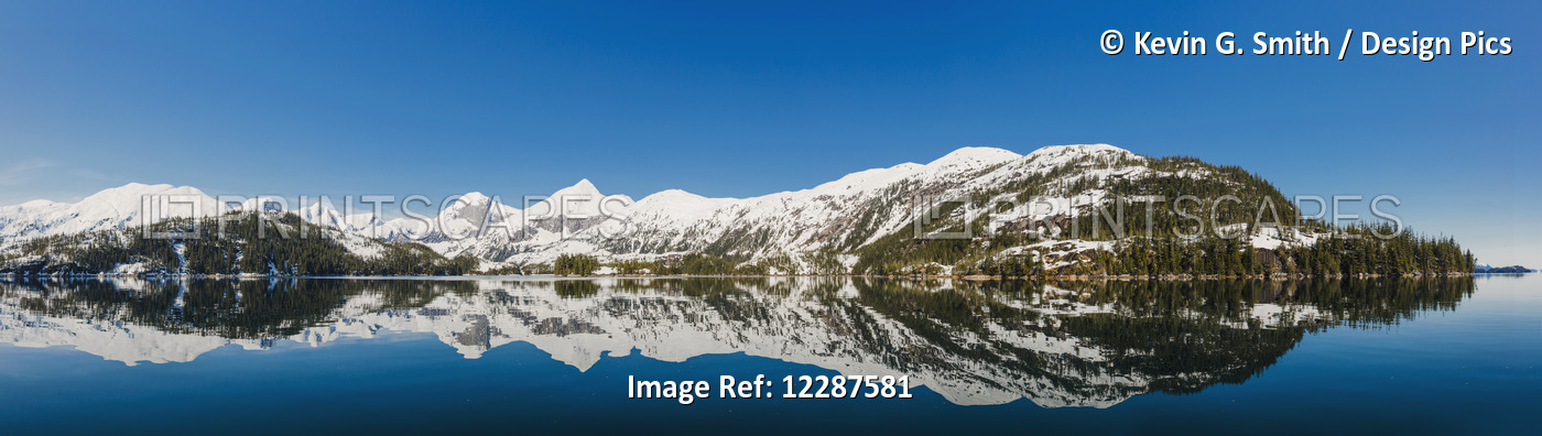 Tranquil Ocean Waters Reflect Snow Covered Mountains On A Clear Day In Kings ...