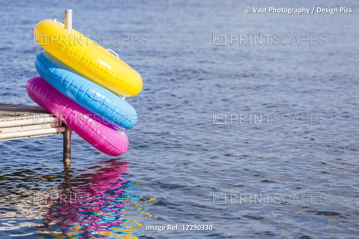 Colorful Inflatable Rings Hanging Off End Of Dock By Balsam Lake; Ontario, ...