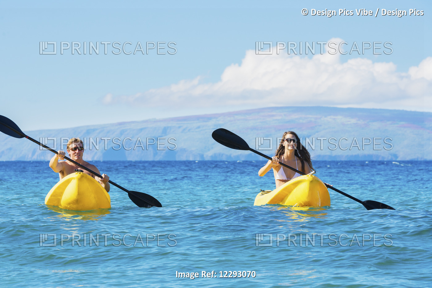 Couple Kayaking In The Ocean On Vacation