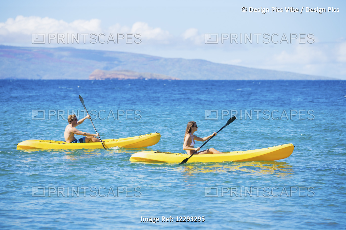 Couple Kayaking In The Ocean On Vacation